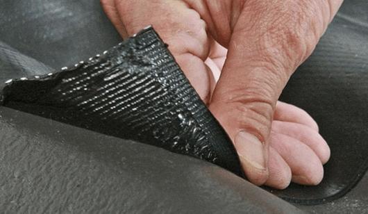 Man laying SmartFlash lead alternative onto a roof