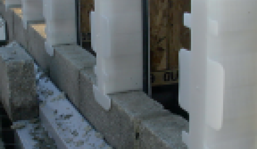 Building site showing a row of joist seals pushed onto joists and laid on blockwork
