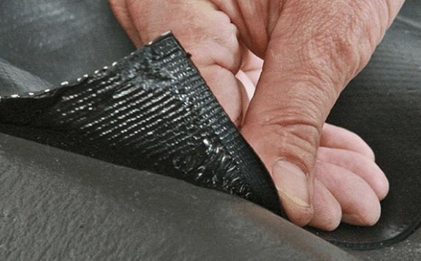 Man laying SmartFlash lead alternative onto a roof