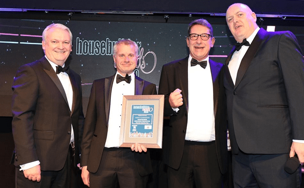Gareth Wright, Sales Director and Mike Challinor, R&D Director on stage being presented with award by Dara O'Brien at black tie event