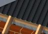 Black, roll-out rafter tray with castellated profile installed over full length of the eaves