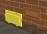 Polypropylene air brick flood defence with yellow push fit cover and terracotta frame installed in a brick wall